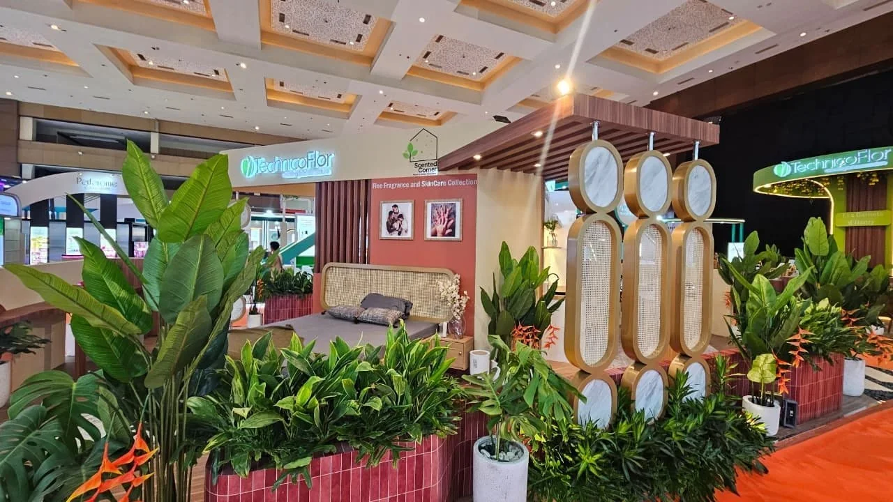 Exhibition lounge with lush plants and warm lighting